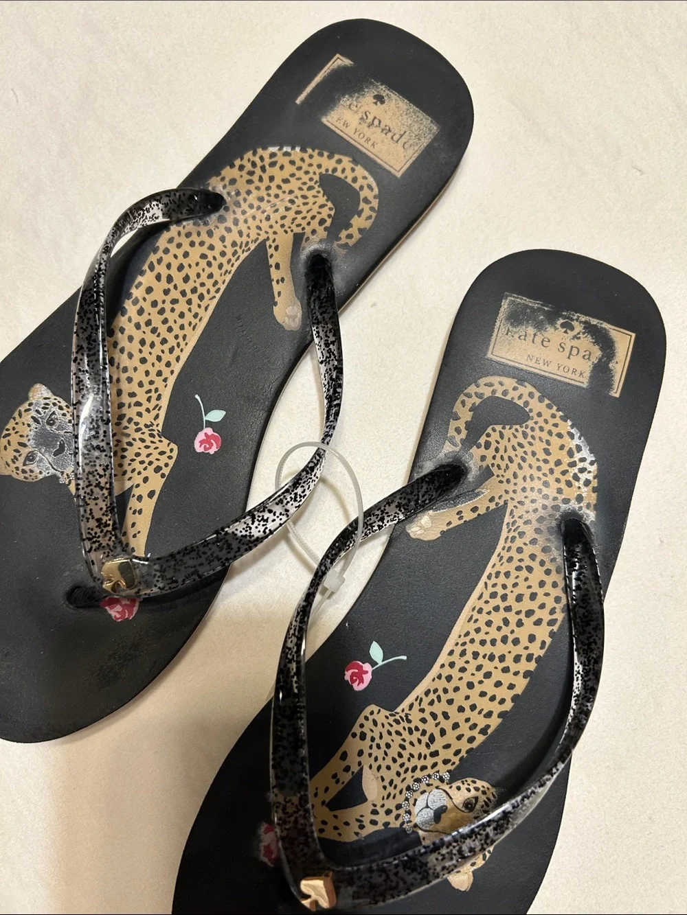 kate spade Black Leopard Print Flip Flop Sandals with Pink Floral Accent